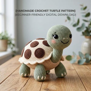 May include: A handmade crochet turtle toy with a sage green head and limbs, a cream-coloured underbelly, and a shell featuring dark brown circular patches. The text [HANDMADE CROCHET TURTLE PATTERN] [BEGINNER-FRIENDLY DIGITAL DOWNLOAD] is visible above.
