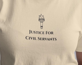 May include: A light beige t-shirt with the text "JUSTICE FOR CIVIL SERVANTS" and a torch graphic. The shirt is short-sleeved and has a crew neck. The model is wearing a black skirt.