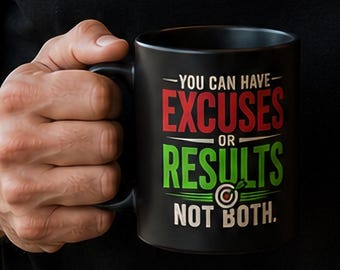 May include: A black ceramic mug featuring the text "YOU CAN HAVE EXCUSES OR RESULTS NOT BOTH." The word "EXCUSES" is printed in red, while "RESULTS" is in green. A small target graphic is positioned between the words "RESULTS" and "NOT BOTH."