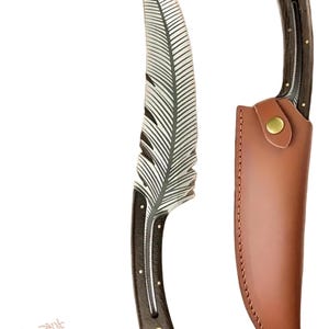 May include: A handcrafted knife with a feather-shaped blade and a dark wooden handle. The blade is silver with etched feather details. It includes a brown leather sheath with a brass button closure. The knife is approximately 25 cm long.