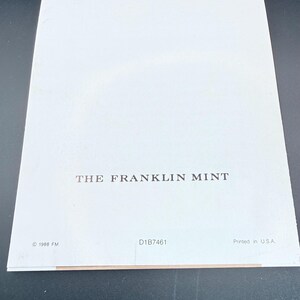 May include: A white paper with the text "THE FRANKLIN MINT" printed in black. The bottom of the paper has the text "&copy; 1988 FM", "D1B7461", and "Printed in U.S.A."