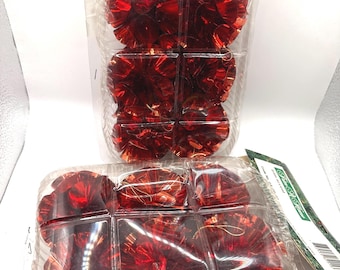 May include: Two clear plastic containers filled with red metallic trim accents. Each container is divided into sections, holding multiple decorative pieces. The packaging includes text: Code No. 04-06-09.