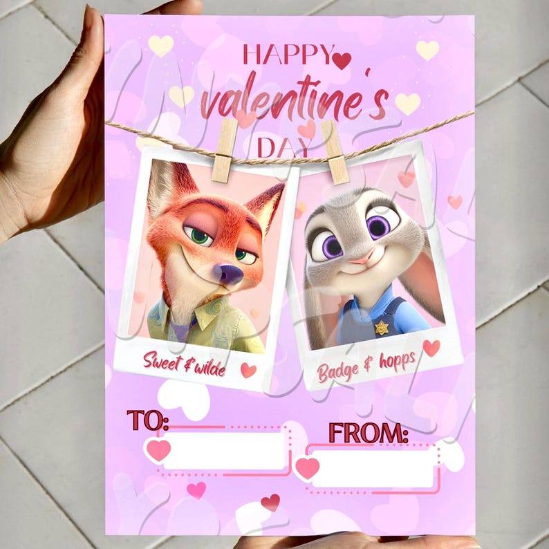 May include: A pink Valentine's Day card with cartoon characters Nick Wilde and Judy Hopps from Zootropolis. The card has hearts and the words "Happy Valentine's Day." The photos are held by wooden pegs.