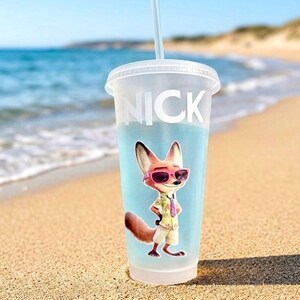 May include: A frosted plastic cold cup with a lid and straw, featuring the name NICK in white capital letters and a graphic of a cartoon fox wearing pink sunglasses, a light-colored patterned shirt, a purple tie, and beige shorts.