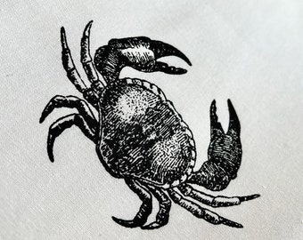 May include: Black and white illustration of a crab with detailed markings on its shell and legs.