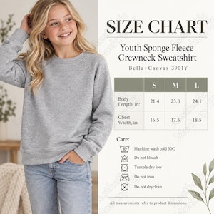 May include: A heather grey crewneck sweatshirt with long sleeves and a ribbed hem. Next to the sweatshirt is a size chart for the Bella+Canvas 3901Y Youth Sponge Fleece Crewneck Sweatshirt, listing body length and chest width in inches.