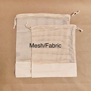 May include: Two beige mesh produce bags with white fabric bottoms and drawstring closures. The bags are stacked on top of each other. The text "Mesh/Fabric" is printed on the bags.