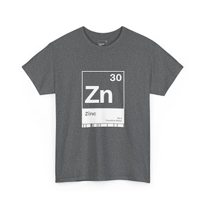 May include: Dark gray t-shirt with a white graphic of the periodic table element Zinc. The graphic includes the symbol Zn, atomic number 30, and the element name. The shirt is made of a soft material.