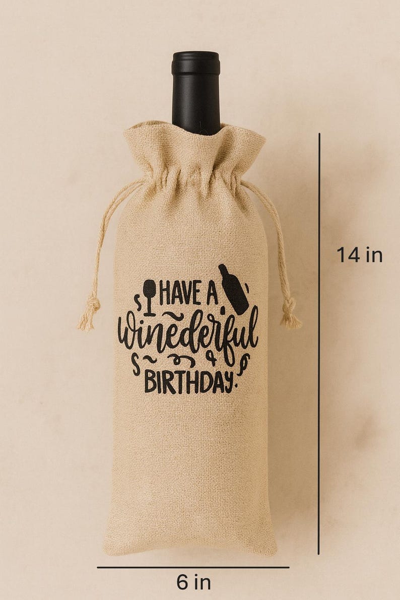 May include: A tan burlap wine bottle gift bag with a drawstring closure, featuring black printed text that reads "HAVE A winederful BIRTHDAY." with icons of a wine glass and bottle. The bag measures 14 inches in height and 6 inches in width.