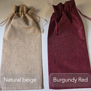 May include: Two tall, rectangular drawstring bags made of a textured woven fabric. One bag is natural beige with matching light-colored drawstrings, and the other is burgundy red with matching dark red drawstrings. Text labels read Natural beige and Burgundy Red.