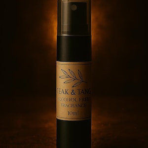 May include: A black fragrance spray bottle with a clear cap. The label reads "TEAK & TANG ALCOHOL FREE FRAGRANCE 10ml." The bottom of the bottle has the text "TEAK & TANG WHERE SCENT BECOMES CEREMONY."