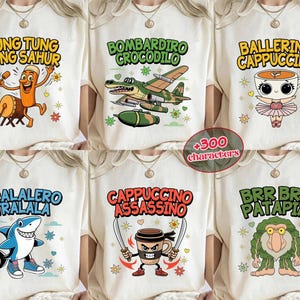 May include: A collection of cream-colored t-shirts featuring colorful cartoon graphics and text. Designs include a character with a drum, a crocodile in a plane, a ballerina in a teacup, a shark, a coffee cup with swords, and a troll-like creature.