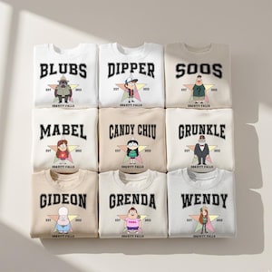 May include: Nine crew neck sweatshirts featuring characters from Gravity Falls. Each sweatshirt has a character name in bold letters above a star graphic with the text "EST 2012" and "Gravity Falls". The sweatshirts are in various colors.