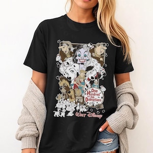 May include: Black t-shirt featuring a graphic from the Disney movie "One Hundred and One Dalmatians." The design includes Cruella de Vil, the dalmatian puppies, and other characters from the animated film. The text "Walt Disney" is also visible.