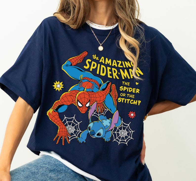 May include: Navy blue t-shirt featuring a graphic of Spider-Man and Stitch with the text "The Amazing Spider-Man, The Spider or the Stitch?". The design includes spiderwebs, stars, and a heart.