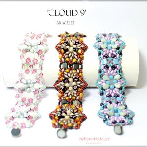May include: Three beaded bracelets with floral designs. The bracelets are in shades of pink, orange, and purple, with silver clasps. The text on the image reads "'Cloud 9' Bracelet" and the artist's name.