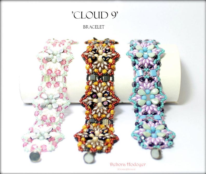 May include: Three beaded bracelets with floral designs. The bracelets are in shades of pink, orange, and purple, with silver clasps. The text on the image reads "'Cloud 9' Bracelet" and the artist's name.