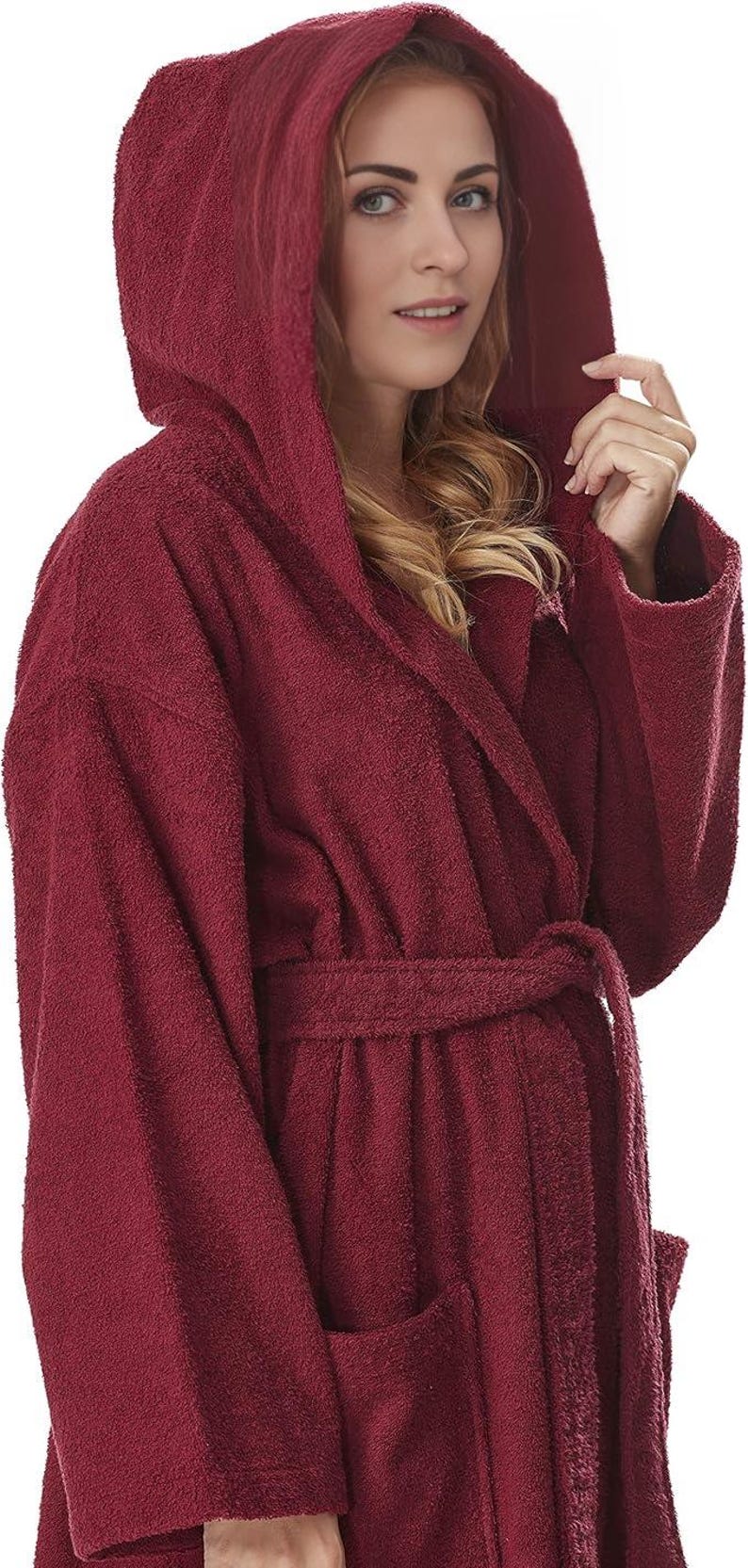 May include: A burgundy hooded bathrobe with a matching belt and pockets. The plush robe is made of a soft, absorbent material, perfect for after a shower or a relaxing day at home.