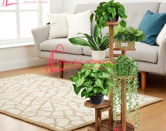 May include: A multi-tiered, dark wood plant stand with several potted plants. The stand has a circular base and multiple shelves of varying sizes. The plants include trailing vines and leafy green plants. The stand is in a living room setting.