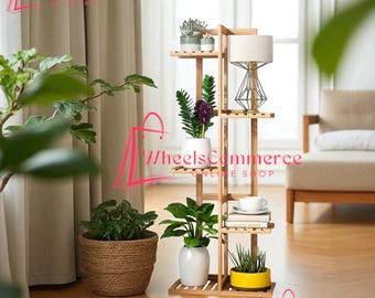 May include: A multi-tiered, light-brown wooden plant stand with various potted plants, a lamp, and books. The stand has a rectangular frame with multiple shelves. Plants are in white, yellow, and brown pots. The background includes a beige curtain and a light-colored couch.