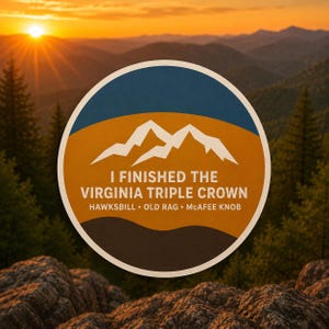 May include: A circular sticker featuring a mountain graphic with the text I FINISHED THE VIRGINIA TRIPLE CROWN and the names HAWKSBILL, OLD RAG, and MCAFEE KNOB. The design uses a blue, orange, and dark brown color palette with white lettering.