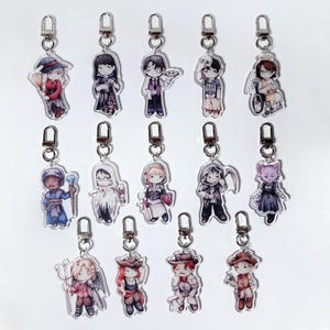 May include: A collection of fourteen acrylic keychains featuring chibi-style character illustrations. Each charm is attached to a silver-toned metal lobster clasp and depicts a unique figure in various outfits, including fantasy, gothic, and historical attire.