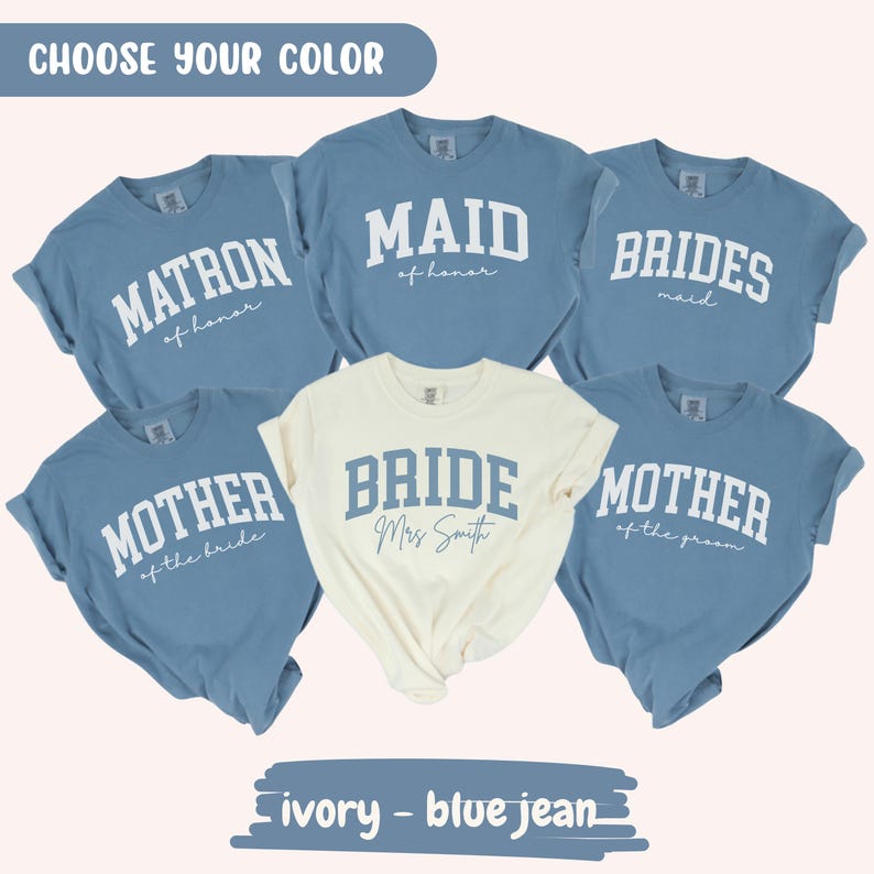 May include: A collection of t-shirts in blue and ivory, each with text for a wedding party. The blue shirts say "MATRON", "MAID", "BRIDES", "MOTHER of the bride", and "MOTHER of the groom". The ivory shirt says "BRIDE Mrs Smith".