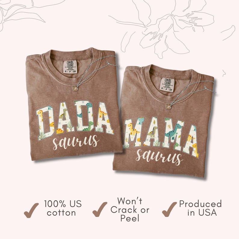 May include: Two brown t-shirts with the words "DADA saurus" and "MAMA saurus" in a white, dinosaur-themed font. The shirts are made of 100% US cotton and produced in the USA.