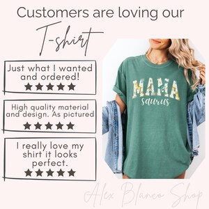 May include: A teal T-shirt with the text "MAMA saurus" in a floral design. The image includes customer reviews and the shop name "Alex Blanco Shop".