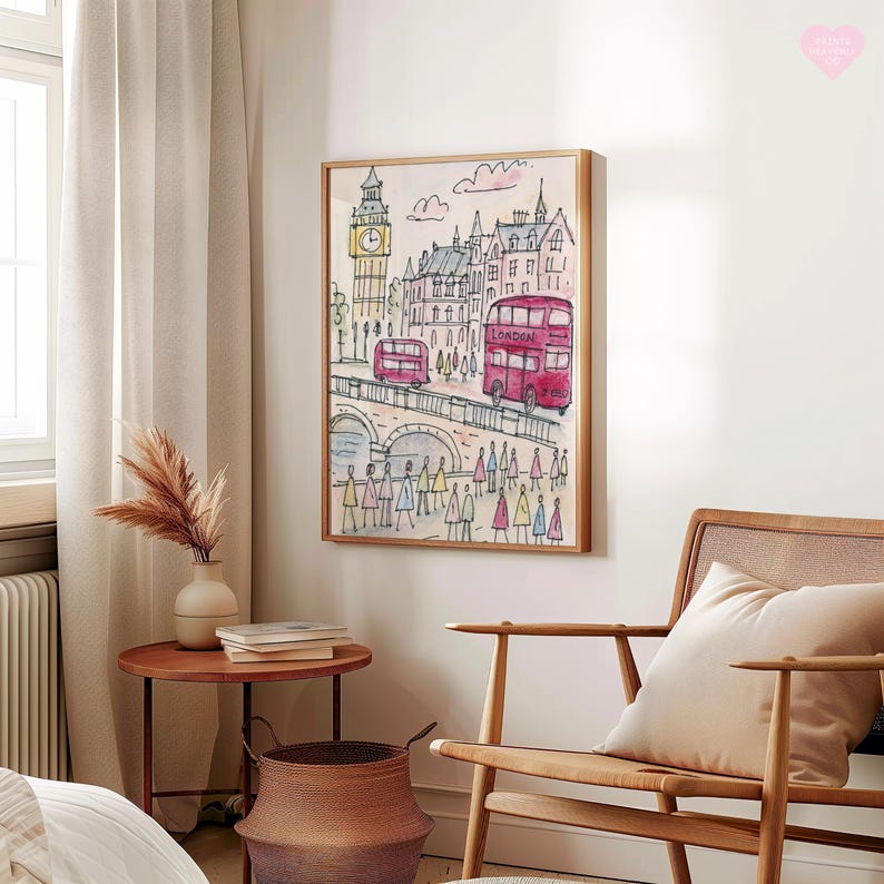 May include: Watercolor painting of London landmarks, including Big Ben and red double-decker buses. The artwork is framed in a light wood frame and depicts a bridge with pedestrians. The style is whimsical and colorful, with a focus on iconic city elements.