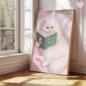 May include: A framed print featuring a fluffy white cat reading a book titled "Romance 101." The cat is lying on a pink surface, with a window and wooden floor in the background. The book has floral illustrations.