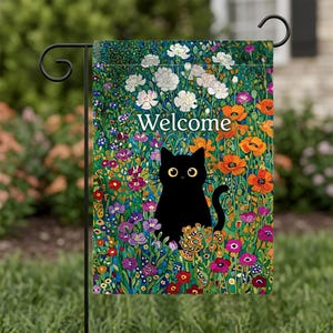 May include: A garden flag featuring a black cat amidst a vibrant floral design. The flag reads "Welcome" in white lettering. The flowers include white, orange, purple, and yellow blooms, set against a green background.