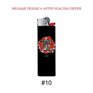 May include: Black lighter with a floral Gemini design. The design features a teal Gemini symbol surrounded by red flowers. The text "Gemini" is below the symbol. The number "#10" is at the bottom.