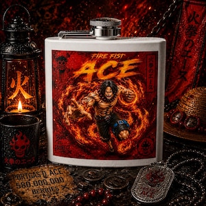 May include: A white metal flask featuring a graphic of the anime character Fire Fist Ace surrounded by flames. The text reads Fire Fist Ace, Born to Protect, and includes a skull emblem. The design is set against a deep red background.