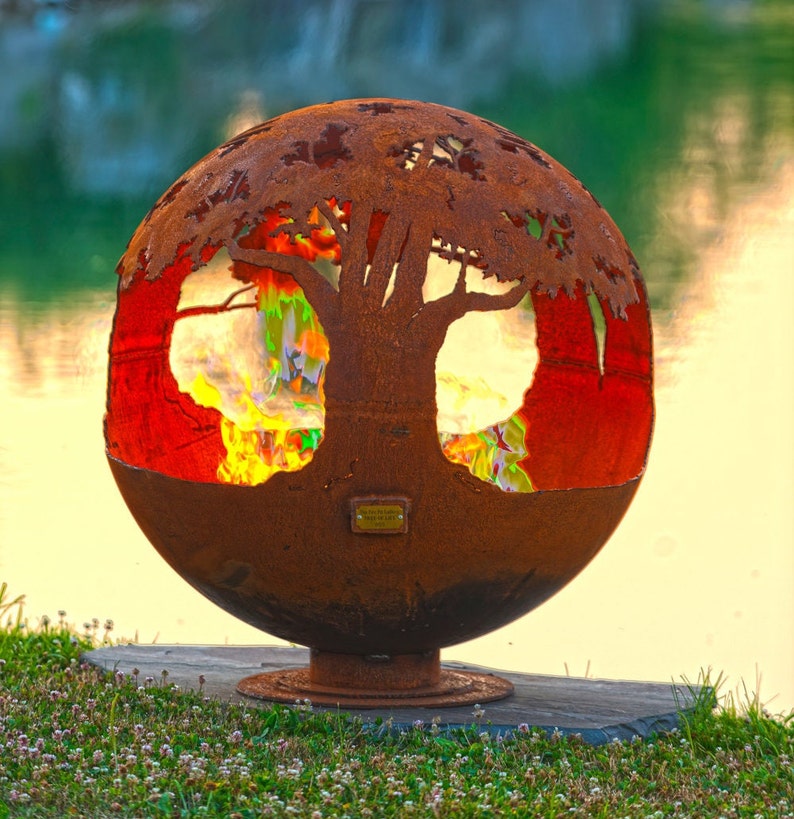 Tree tops encircle this round earth shaped sphere reminding its viewers of the beauty and importance of trees to our planet. Sculptural firebowls by Melissa Crisp are the perfect choice in functional art for your backyard.