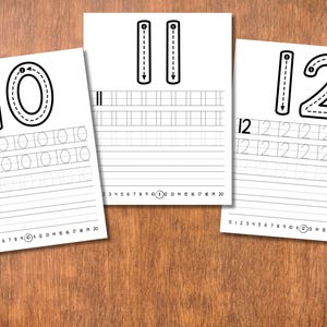 May include: Three white sheets of paper with black numbers for tracing. The numbers 10, 11, and 12 are displayed at the top of each sheet. Each sheet has lines for tracing the numbers and a number line at the bottom.