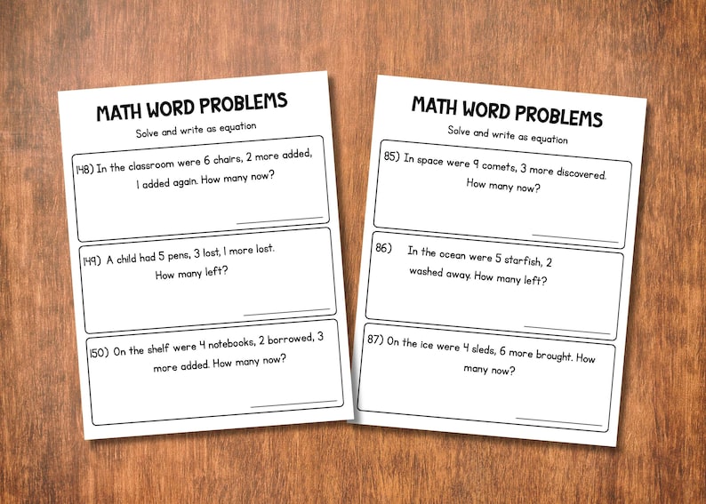 May include: Two white worksheets with math word problems on a wooden surface. The worksheets have the title "MATH WORD PROBLEMS" and include several addition and subtraction problems. The problems are numbered and have space for answers.