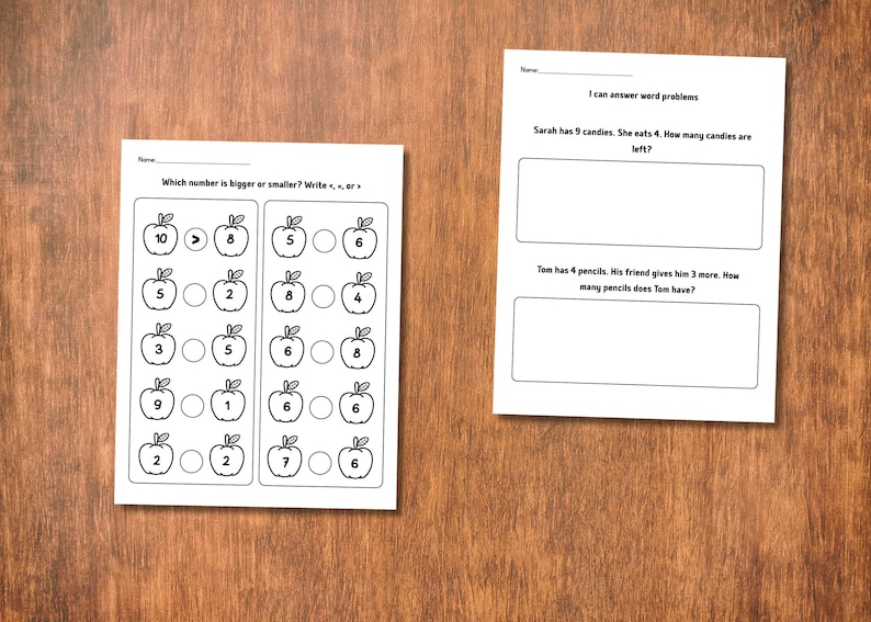 May include: Two white worksheets on a wooden surface. One worksheet asks "Which number is bigger or smaller?" with apple illustrations and number comparisons. The other asks word problems about candies and pencils.