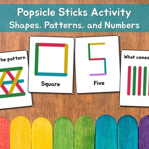 May include: Educational activity cards featuring shapes, patterns, and numbers made with popsicle sticks. The cards include a square, the number five, and pattern recognition exercises. The text "Popsicle Sticks Activity" is at the top.