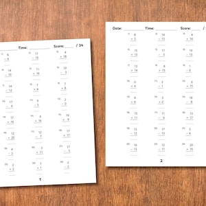 May include: Two white worksheets with math problems, including addition and subtraction, are displayed on a wooden surface. The worksheets have sections for date, time, and score. The score is out of 24.