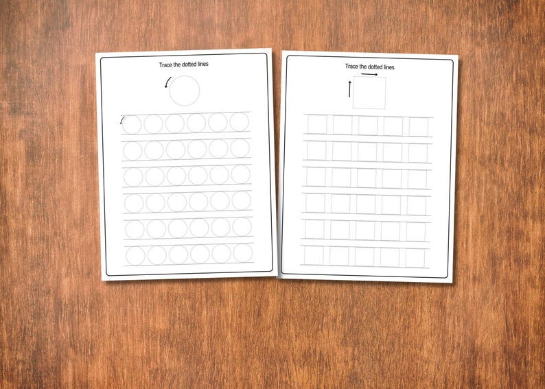 May include: Two white worksheets with black line drawings and text on a wooden surface. The worksheets have dotted lines for tracing shapes and the text "Trace the dotted lines". One worksheet has circles, the other has squares.