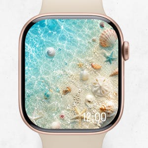 May include: A rose gold smartwatch with a light beige silicone band. The digital display features a high-resolution image of a sandy beach with turquoise water, various seashells, starfish, and a small crab. The time 12:00 is displayed in white.