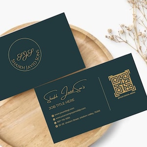 Può includere: Due biglietti da visita verde scuro con scritte dorate e un logo dorato. Un biglietto presenta il nome dell'azienda "Shaikh Javid Sons" e le informazioni di contatto. L'altro biglietto ha un logo e le iniziali dell'azienda "SJS".