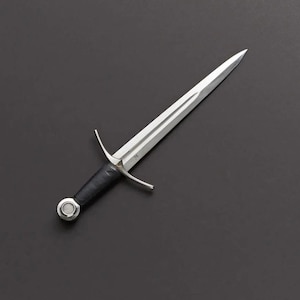 May include: A silver dagger with a double-edged blade and a black leather-wrapped handle. The dagger features a crossguard and a circular pommel. The blade has a central fuller. The overall design suggests a medieval or historical theme.