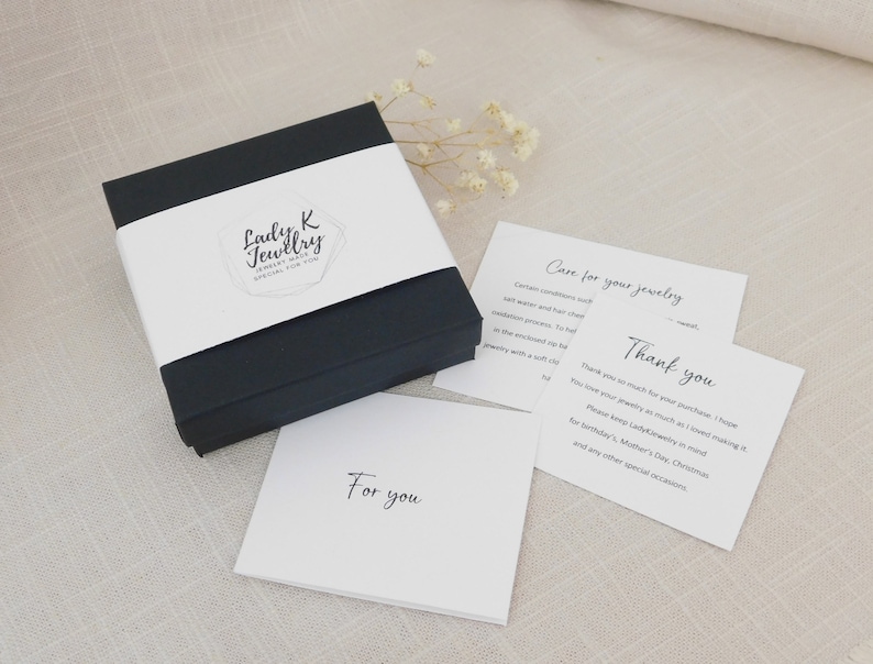 May include: A black jewelry box with a white band displaying "Lady K Jewelry Special for You." Cards nearby say "Care for your jewelry" and "Thank you." A card reads "For you."