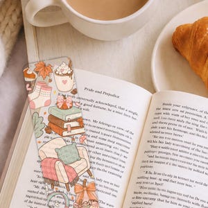 Fall season bookmark printable featuring stacked books, pumpkins, headphones and cozy chair