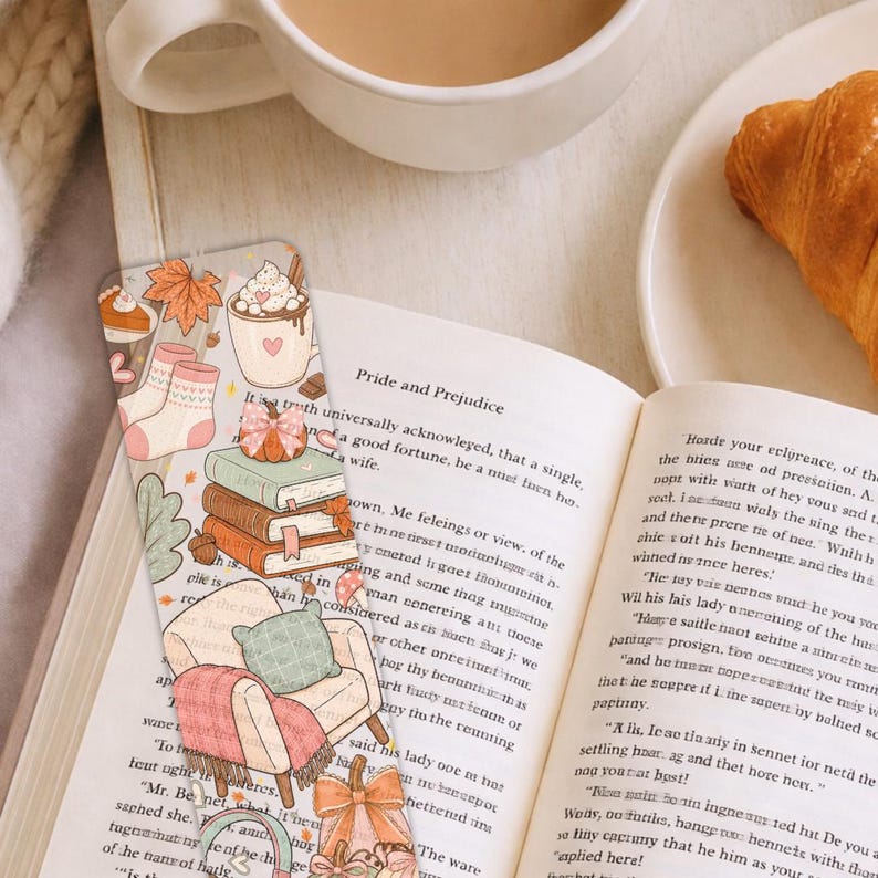 Fall season bookmark printable featuring stacked books, pumpkins, headphones and cozy chair