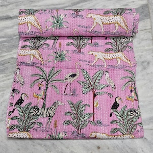 Puede incluir: Colcha de algodón rosa con un estampado repetido de leopardos, cebras, pájaros y plantas tropicales. La colcha está cosida a mano con un diseño detallado, mostrando un vibrante tema de la jungla. La colcha está enrollada, mostrando el diseño.