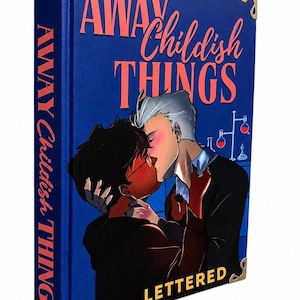 Pu&ograve; includere: Un libro con copertina rigida blu intitolato Away Childish Things con angoli dorati. La copertina presenta un'illustrazione di due persone che si baciano, con vetreria da laboratorio sullo sfondo. Il titolo &egrave; stampato in corallo e bianco.