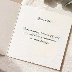 May include: A square off-white greeting card opened to reveal black printed text that reads: Dear Customer. Print a message on the inside of the card or leave it blank and handwrite your own personal message. The card has a smooth, matte finish.